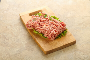 Raw minced pork meat over board