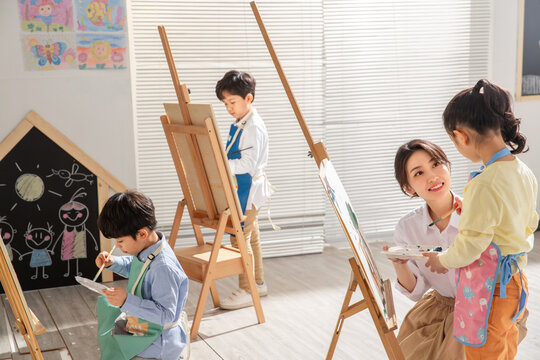 Naklejki Young women to teach the children in art class 