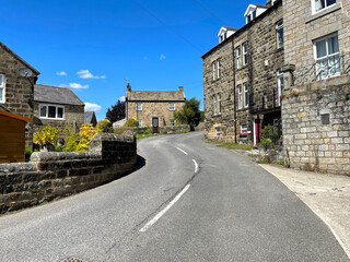 View up, Hartwith Bank, with old  cottages, set against a blue sky in, Summerbridge, Harrogate, UK