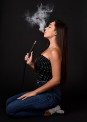 Beautiful  and sexy girl smokes hookah, sheesha. Sexy woman smoking. The pleasure of smoking.
