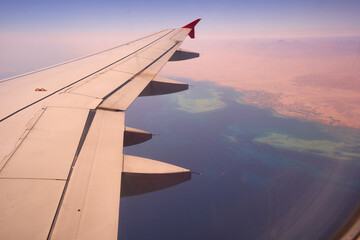Obraz premium beautiful view from the airplane window on the red sea with coral reefs of the Sinai Peninsula Egypt