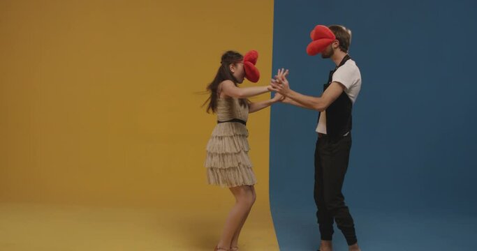 Lip as a head . Couple dancing . Duet dancing funny dance . Boy and girl dancing classic or country dance and sending air kiss with head lips . Shot on RED EPIC Cinema Camera on colorful background .