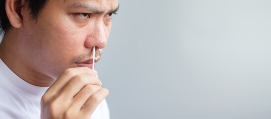 man swab COVID-19 testing by Rapid Antigen Test kit. Coronavirus Self nasal or Home test, Lockdown and Home Isolation concept