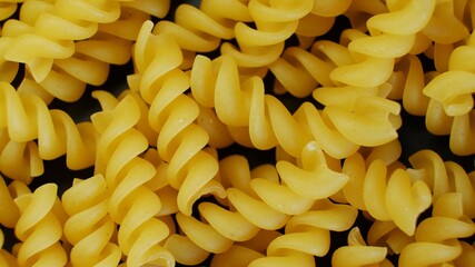 Macaronis on dark background strongly zoomed in with copy space