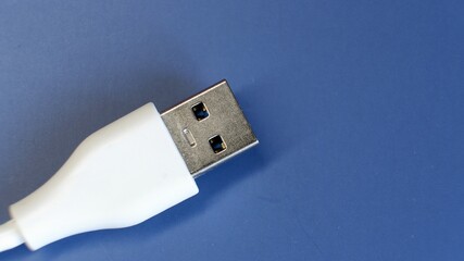 White USB connector on blue background