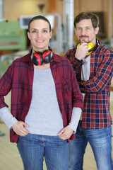 man and woman workers in carpentry workshop