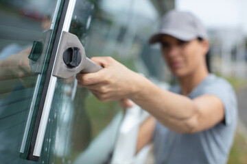 professional cleaner cleaning windows at site