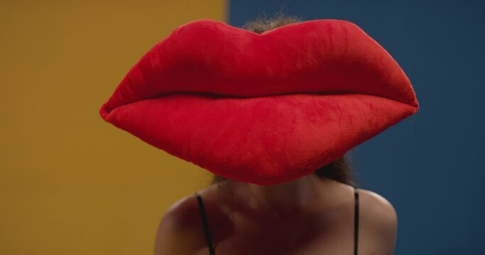 Girl with a lip as a head making the gesture of being shut up. Funny video of a woman, who show silence gesture on big lips by finger. lady making shush gesture touching mouth with finger . 