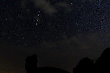 Night landscape with Perseid meteor in Barruecos. Spain.
