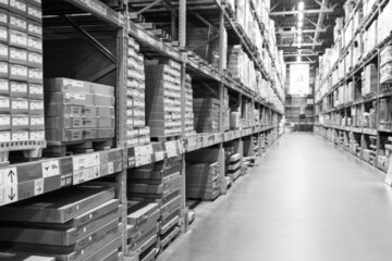 A black and white defocused image of a store warehouse, or factory warehouse. Industrial theme.