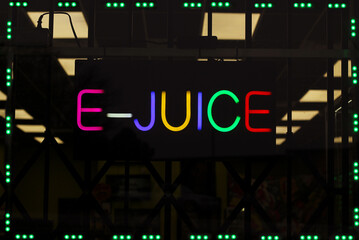 Colorful Neon E-Juice Sign in Smoke Shop Window