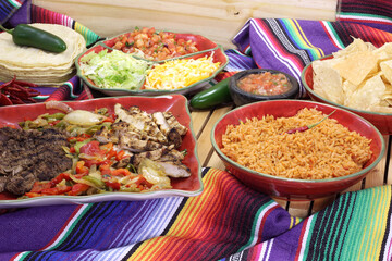 Beef and Chicken Fajita Dinner With Rice and Tortillas in Rustic Setting