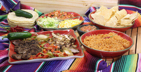 Beef and Chicken Fajita Dinner With Rice and Tortillas in Rustic Setting