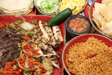 Beef and Chicken Fajita Dinner With Rice and Tortillas in Rustic Setting
