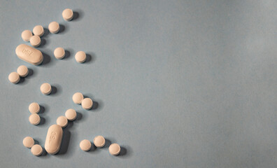 Fototapeta na wymiar white pills on a blue background