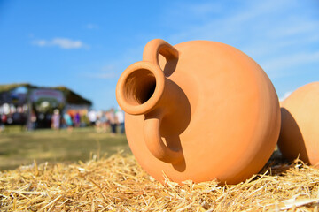 BILSK, UKRAINE – 14 AUGUST 2021: Clay amphora lies on the ground during the historical festival...