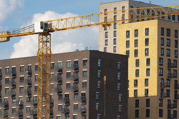 Construction of new multi-storey buildings using cranes.