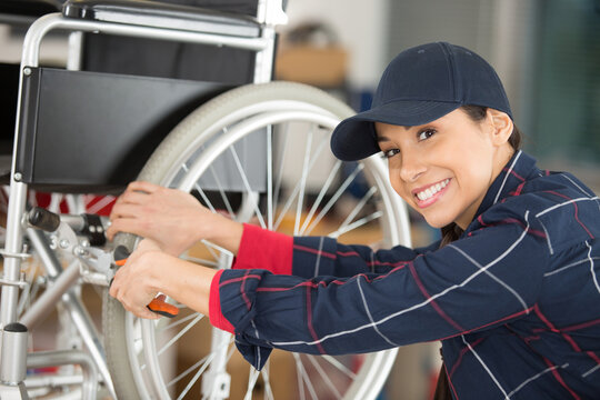 female mechanic maintaining a wheelchair