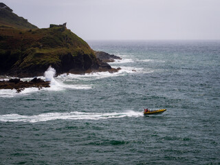 A speed boat exiting the estuary into the English Channel at Fowey in Cornwall