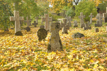 Stone crosses in the old cemetery in autumn