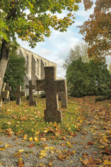 Stone crosses in the old cemetery in autumn