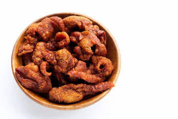 Chispy fried chicken skin in wooden bowl on white background.
