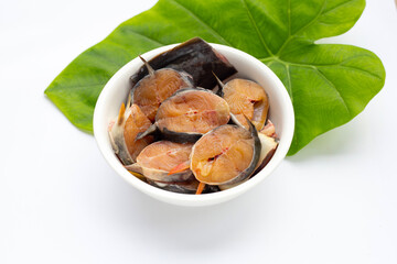 Catfish cut pieces in white bowl on white background.