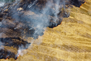 Aerial view of burning stubble in a farm field