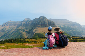 Hikers taking a break along the Logan Pass in Glacier National Park, Montana USA. Logan Pass is...