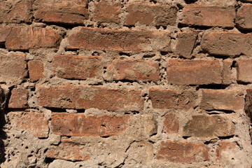 Old red brick wall on rustic house outdoor. Close up and copy space. Retro background and texture concept