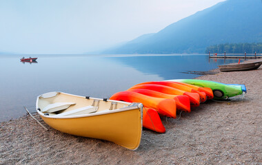 Overview of Lake McDonald after sunset with kayaks in foreground. Lake McDonald is the largest lake in Glacier National Park in Flathead County in the U.S. state of Montana