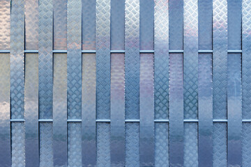 Close up of the steel colored metal fence.