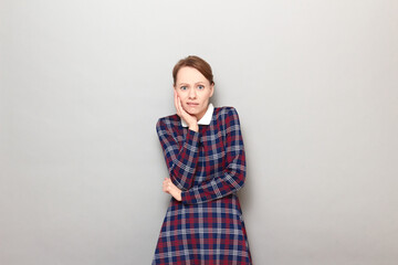 Obraz premium Portrait of sad unhappy shocked young woman touching cheek with hand
