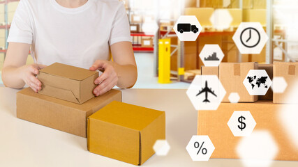 Fototapeta na wymiar Logistics planning concept. Close-up of boxes in hands. Logistics planning symbols in foreground. Logistician prepares goods for shipment. Concept - Logistics career. Delivery planning.