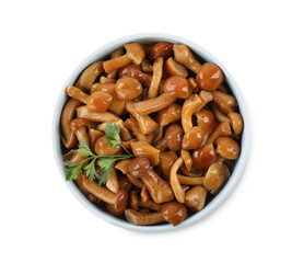 Delicious marinated mushrooms in bowl isolated on white, top view
