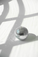Disco ball on white background with hard shadows