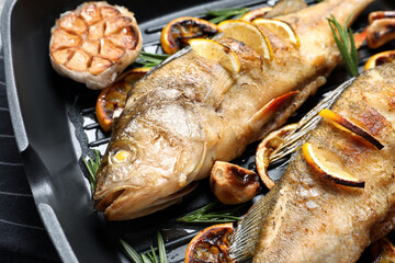 Tasty homemade roasted perches in grill pan, closeup. River fish