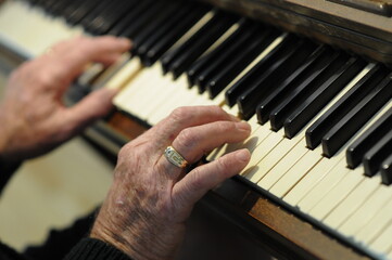 Senior hands on piano keys