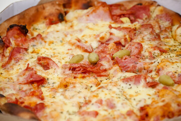 Large sliced Canadian chicken pizza with delicious flavor.
