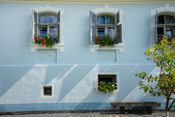 blue house in Romania Brasov, village Roades, 2019 and flowers at the window