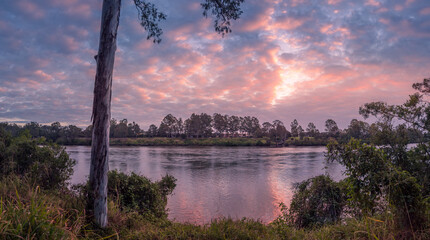 Panoramic Riverside Sunset with Cloud Reflections