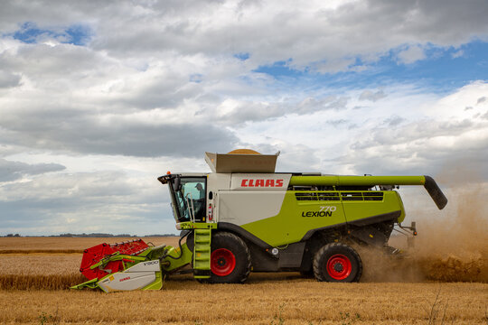 Dorie, Canterbury, New Zealand - January 19 2019: a combine harvester working in a barley field in summertime