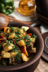 Tasty cooked dish with potatoes in earthenware, closeup