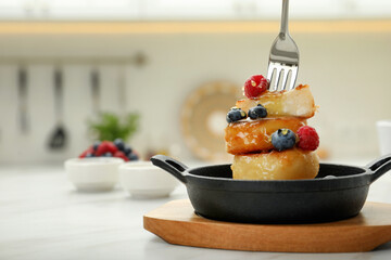 Delicious cottage cheese pancakes with fresh berries and honey served on white table. Space for text