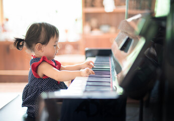 Little Asian cute girl playing piano © Thodsapon