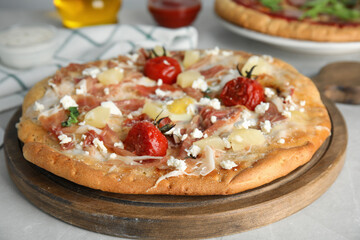 Delicious homemade pita pizza on light table, closeup