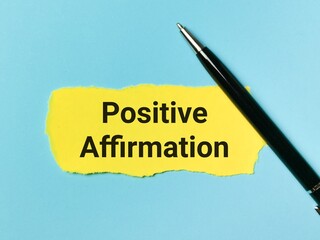 Positive affirmation written on yellow paper strip with a pen.