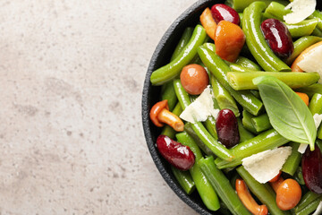 Delicious salad with green beans, mushrooms and cheese on light grey table, top view. Space for text