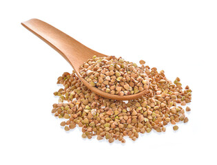 buckwheat seeds in wood spoon on white background