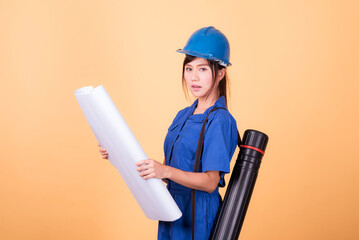 Young Asian female engineer working deliberately isolated on yellow background.